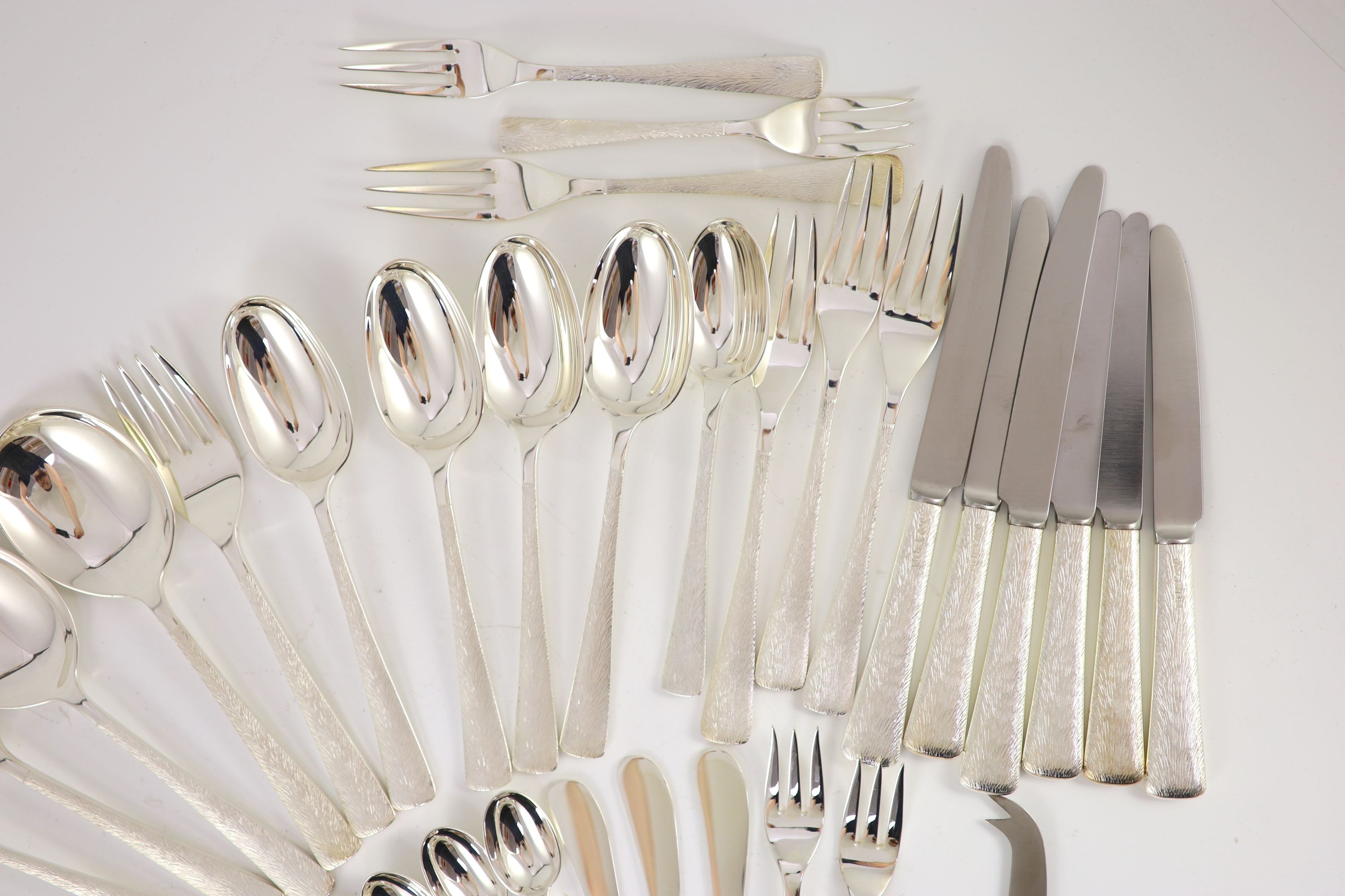 A good part textured silver canteen of cutlery for six by Adrian Gerald Benney